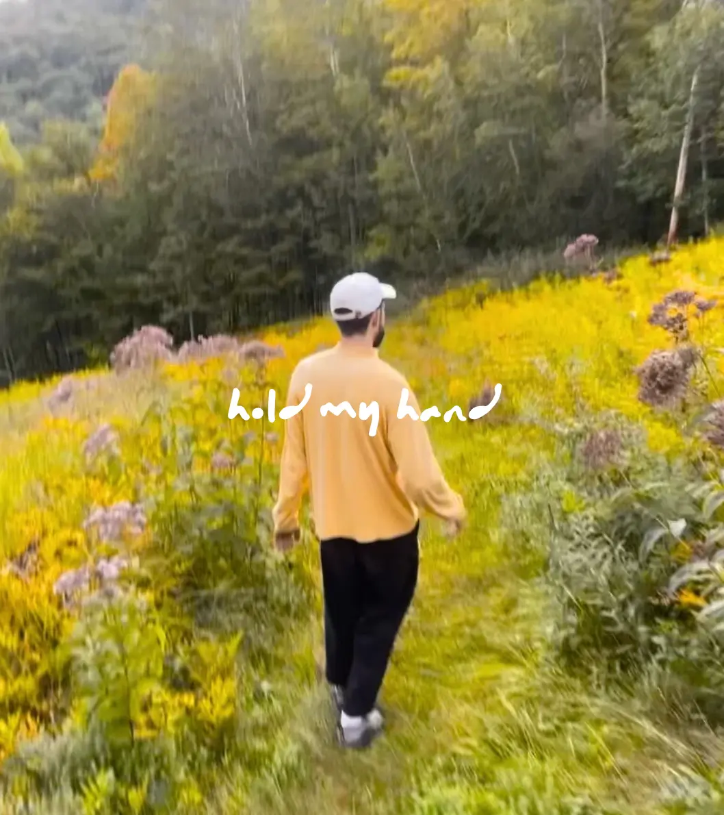 Alec walking through a field of goldenrod